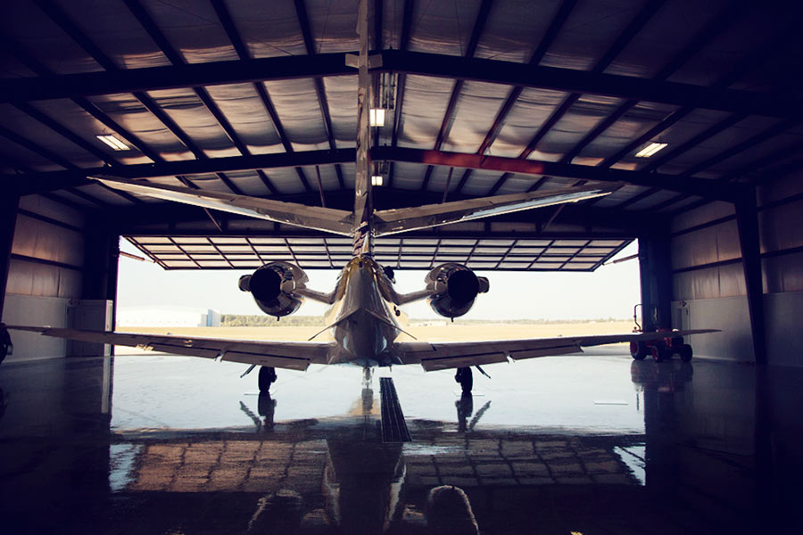Plane in hangar with hydraulic door, looking out